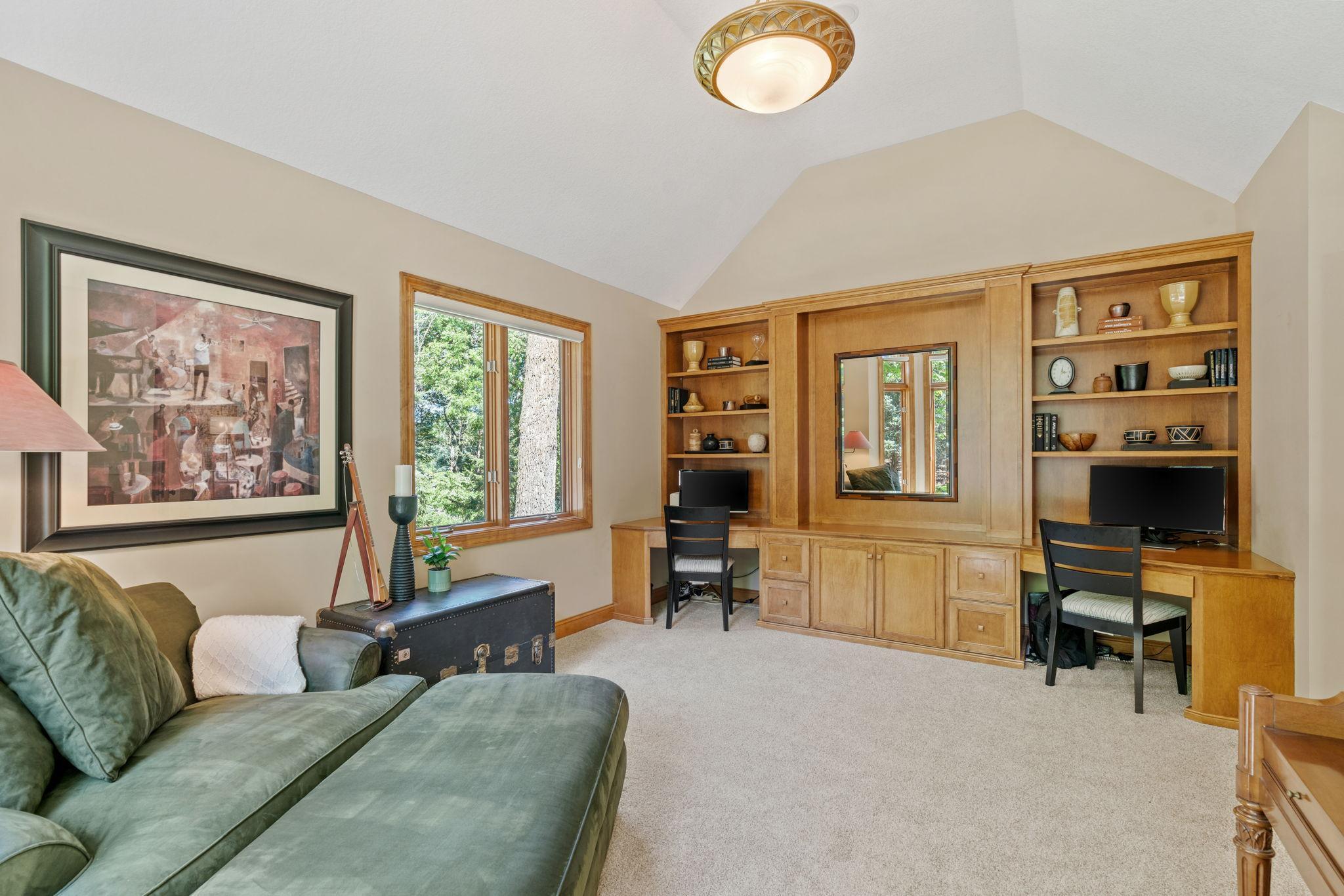 Main-level bedroom with maple built-ins, currently used as an office.