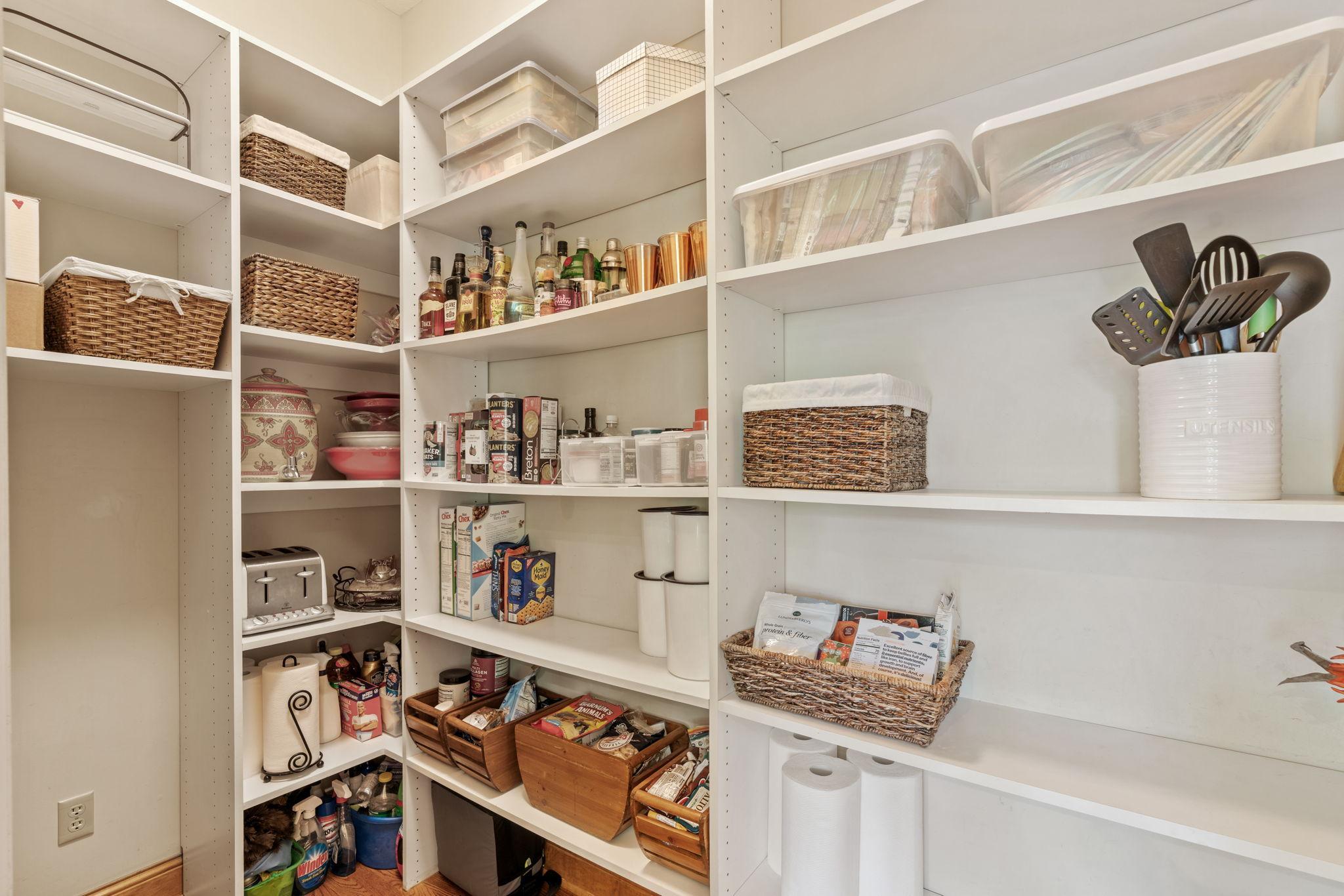 Walk in pantry with custom shelving.