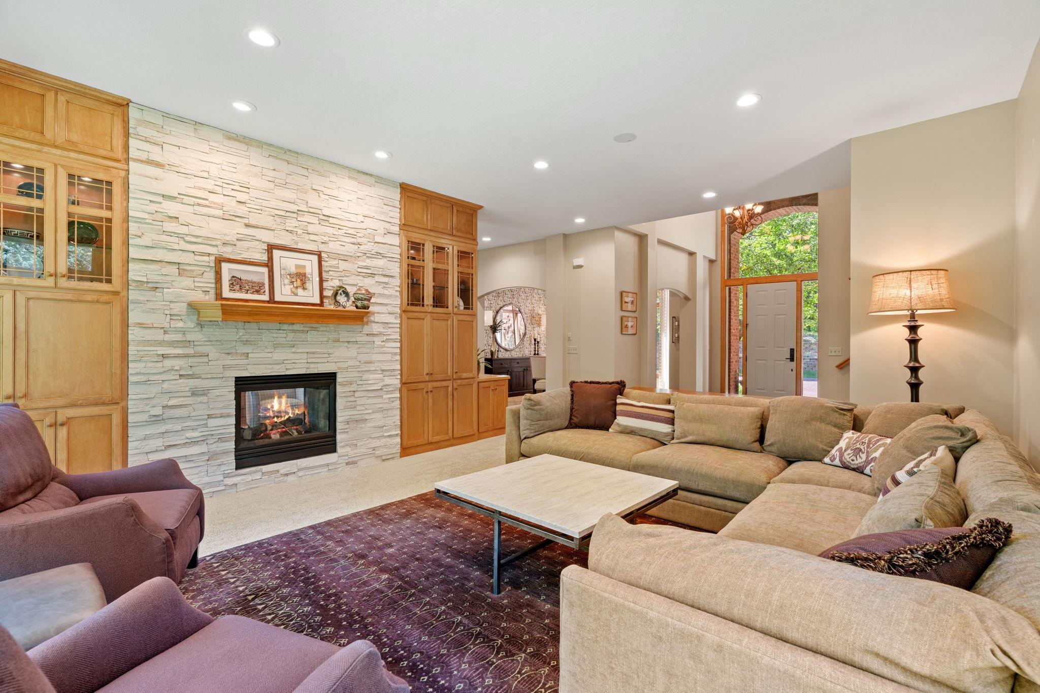 Main level living room with dual sided fireplace.