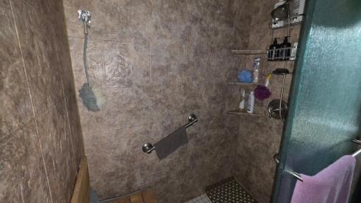 Beautiful updated shower with built in shelving and grab bars!