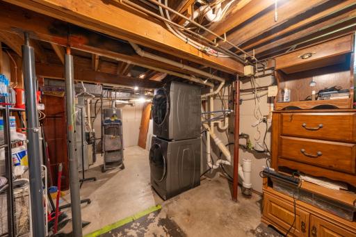 Huge utility / laundry room with stackable washer and dryer and shelving!