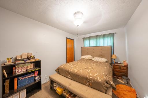 Second bedroom on main level with ceiling fan and walk in closet!