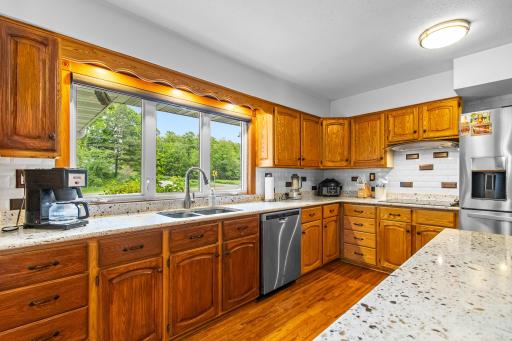 Oak hardwood floors along with oak kitchen cabinets.