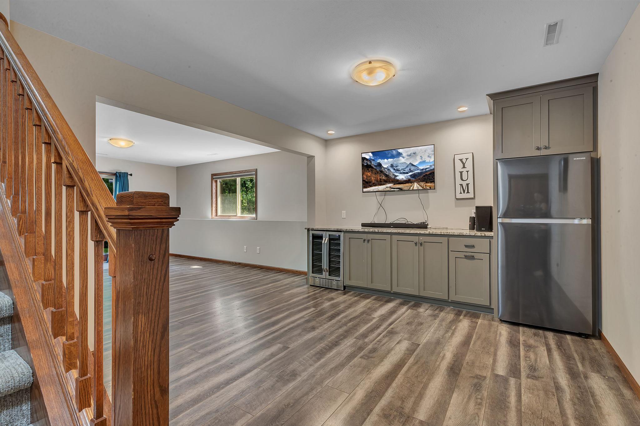 Lower level has a large counter area with a beverage refrigerator and full size refrigerator, ideal for entertaining