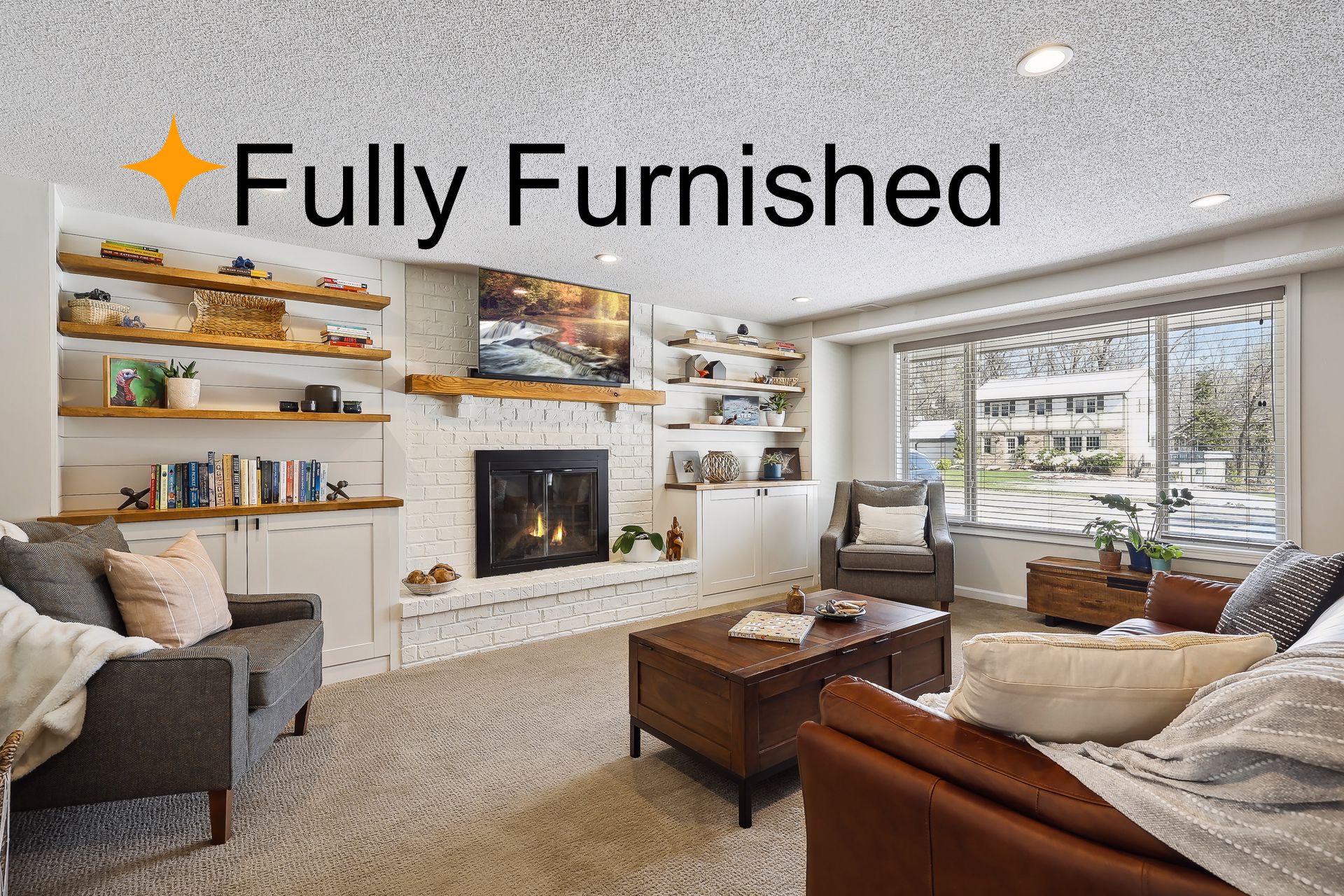 Fully furnished! This main floor living room features warm furnishings and updated built-ins for storage.