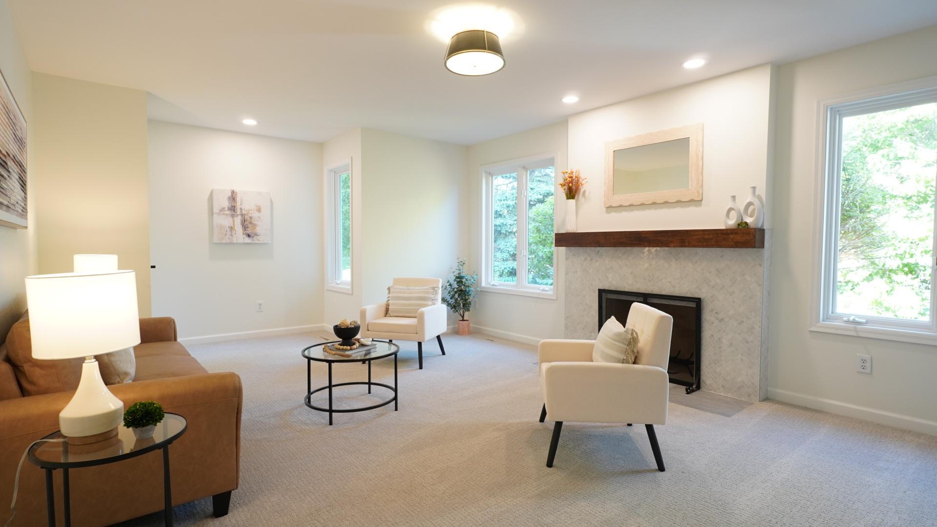 The bright, spacious, and versatile second bedroom with a closet and compliant egress is staged as a den.