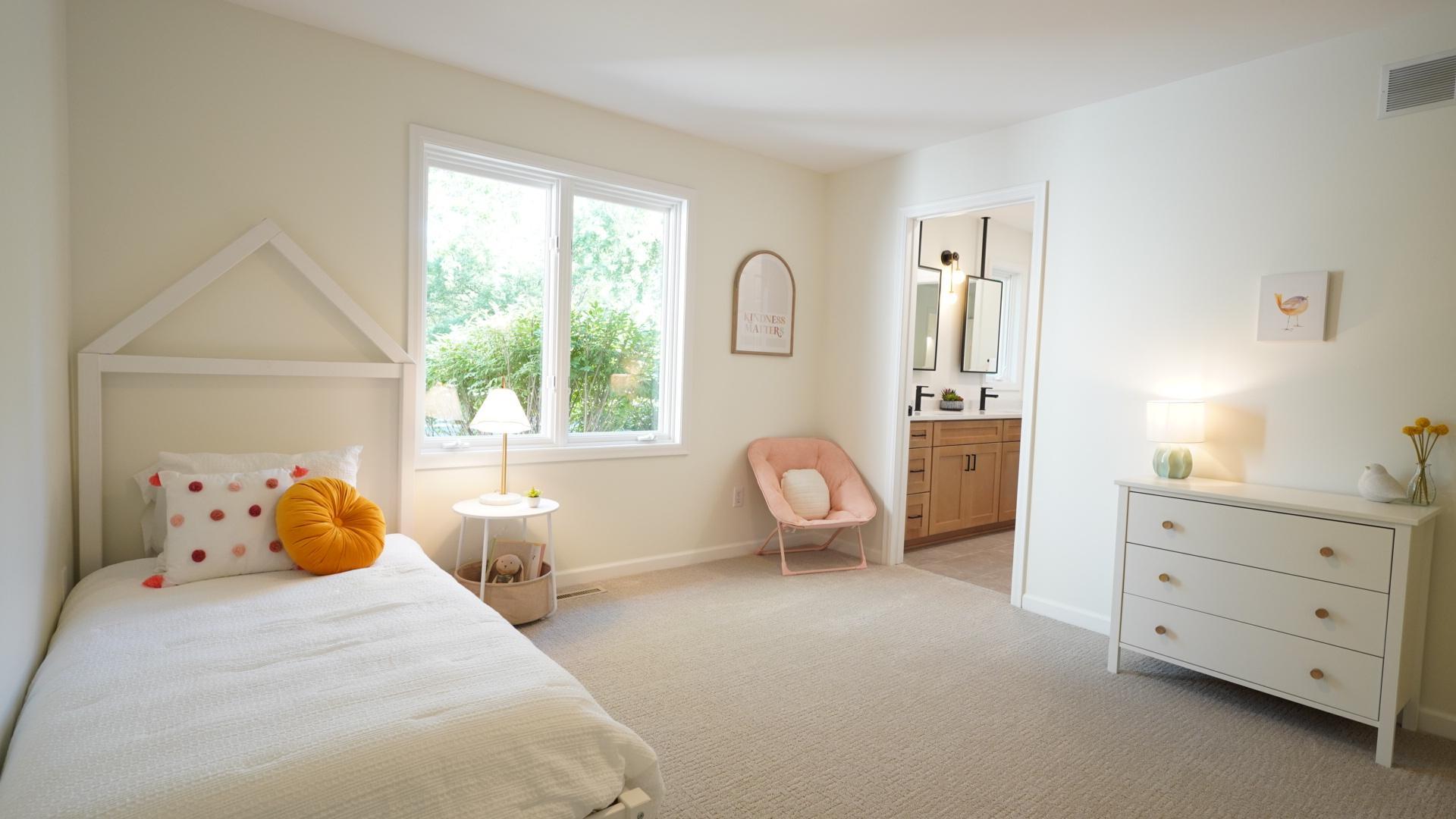 Bedroom 3, staged as a little girls' room, features new lighting, carpet, paint, and is connected to Bedroom 4 via a Jack-and-Jill bath.