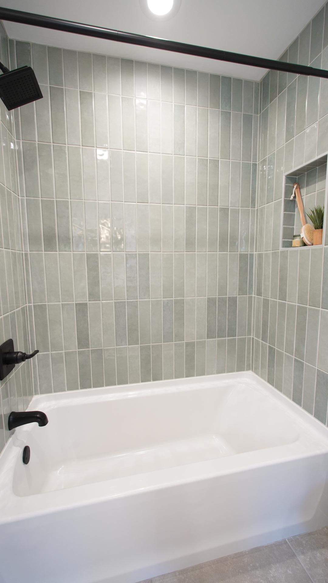 The brand new tub in the Jack and Jill bath features custom tile work in a gorgeous light sage color and new plumbing fixtures.