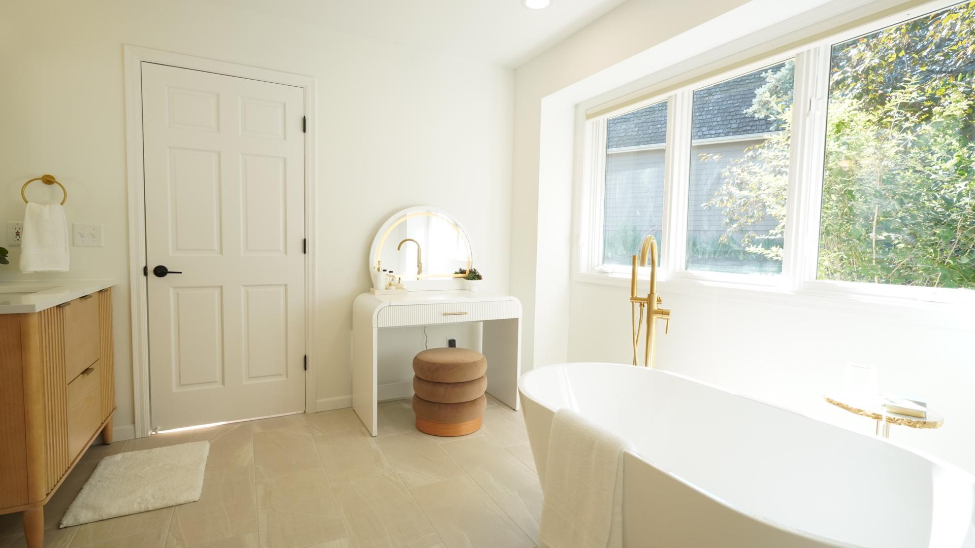 The spacious primary en-suite bath includes a separate soaking tub and ample space for a makeup vanity.