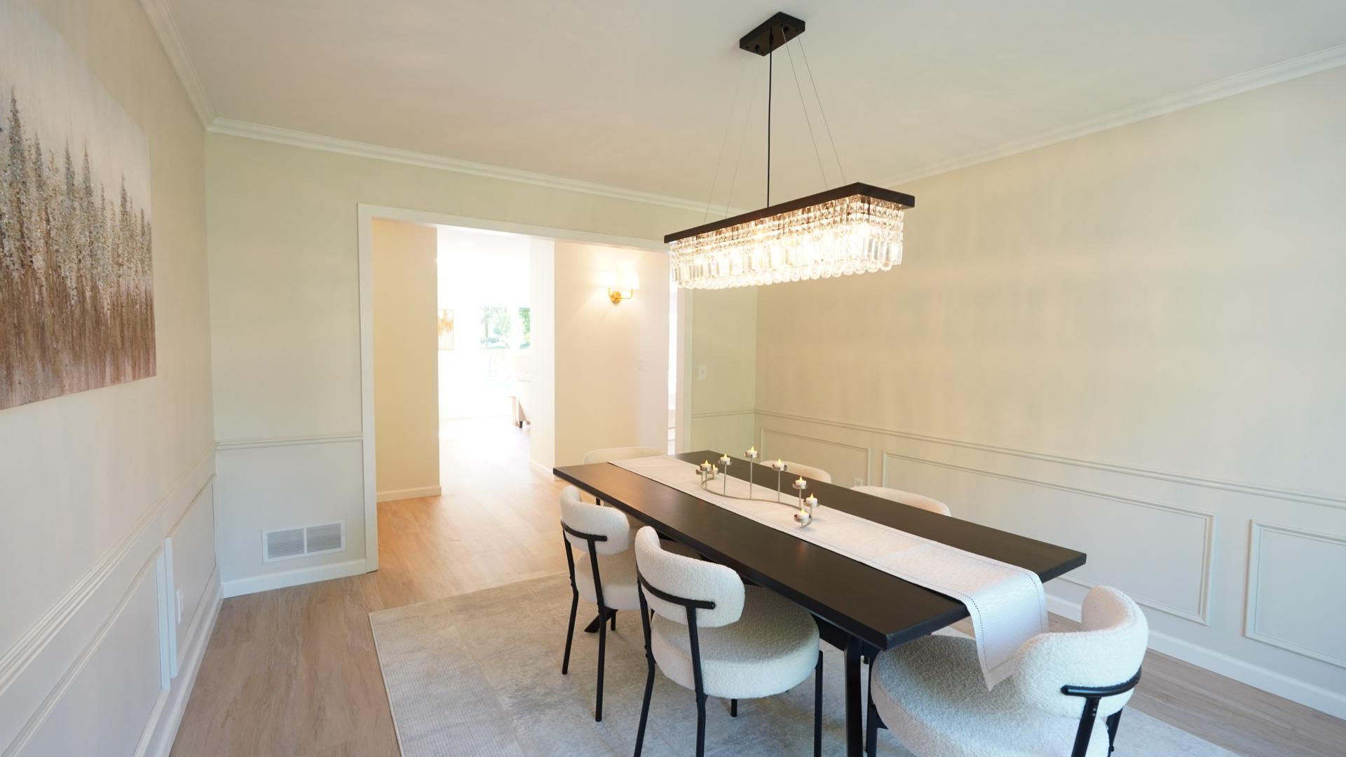 The sophisticated and stunning dining room, right off of the kitchen, can house a large dining table perfect for both dinner parties and holiday celebrations.
