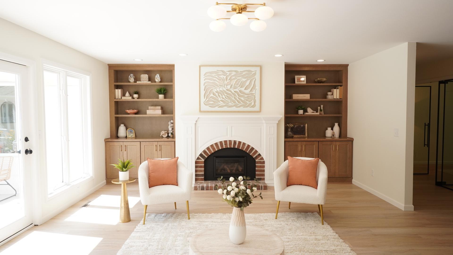 Anchored by the designer light fixture above, the living room features a brand new gas fireplace flanked by custom wood cabinetry.