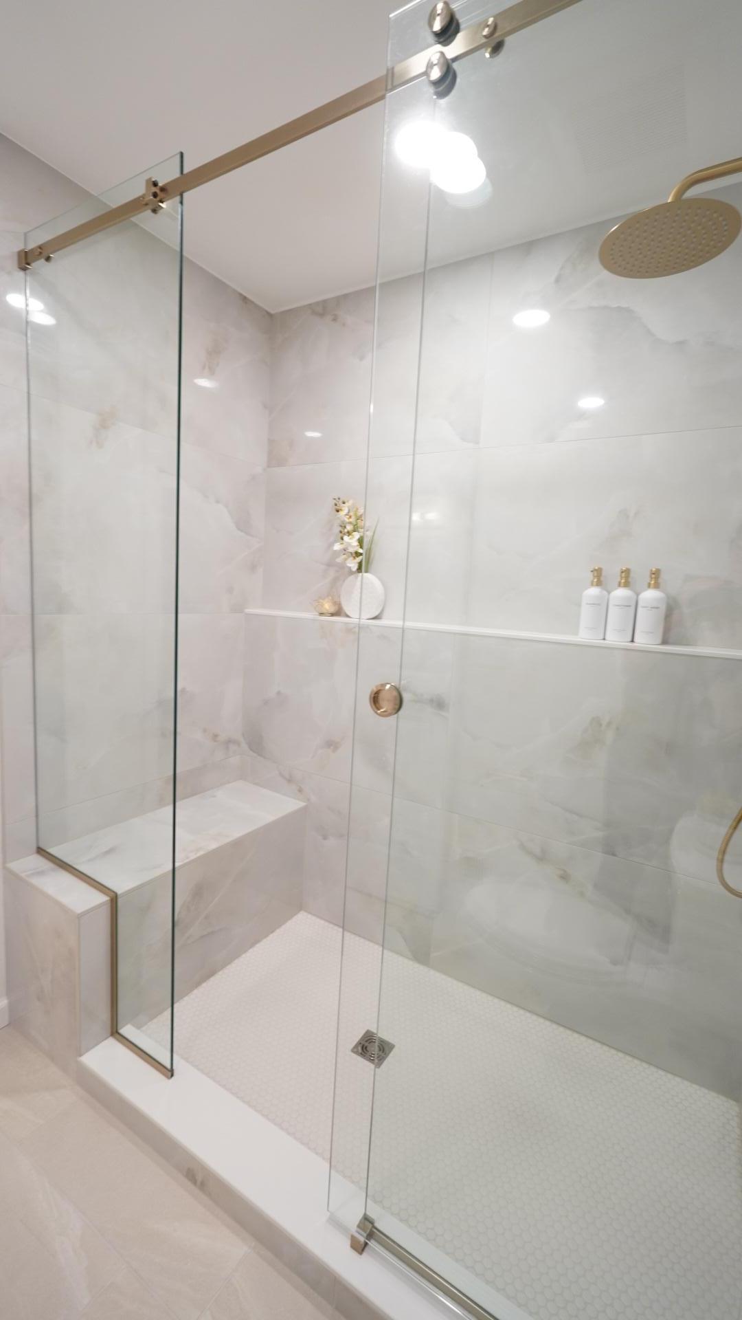 The spacious owners shower is everything high design and functional with both a built-in bench and a wall-to-wall shelf.