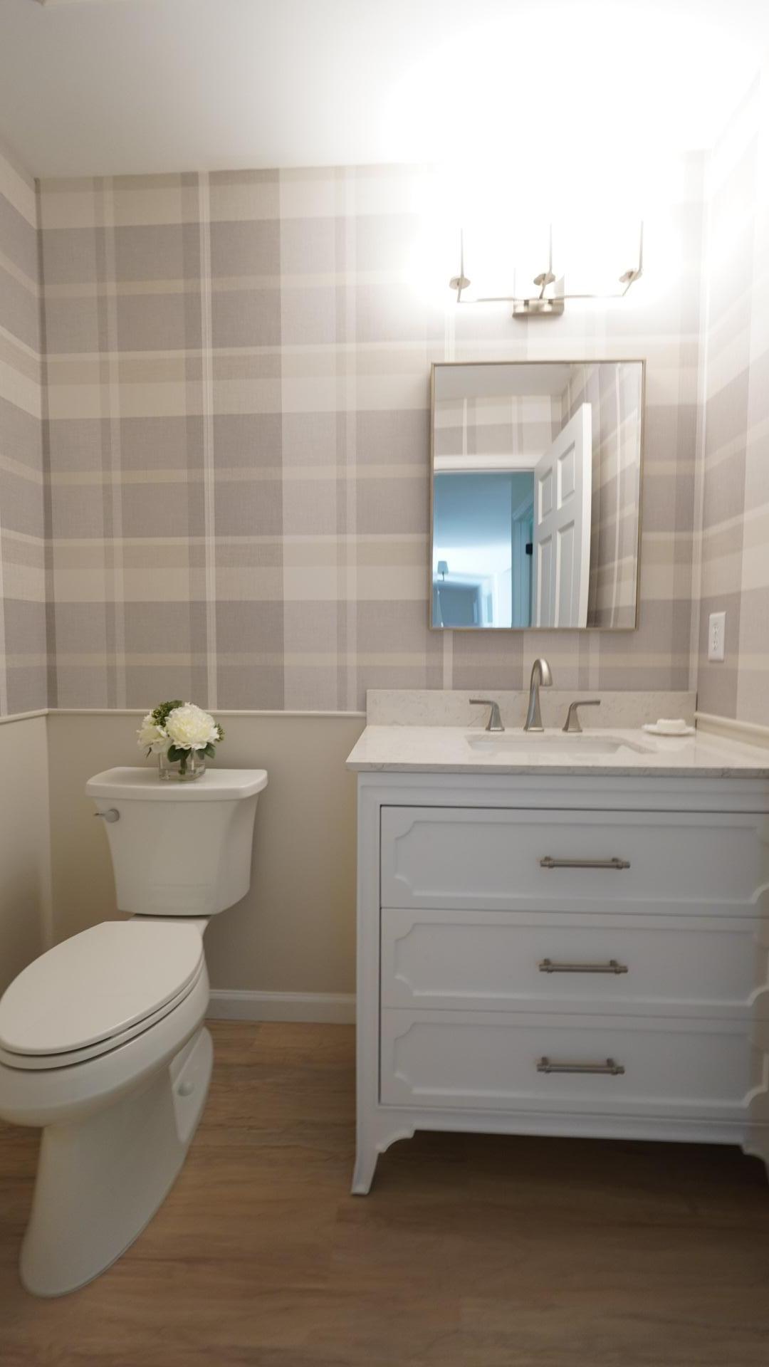 The brand new powder room between bedrooms 1 and 2 is beautifully appointed with wallpaper, a new vanity and new fixtures.