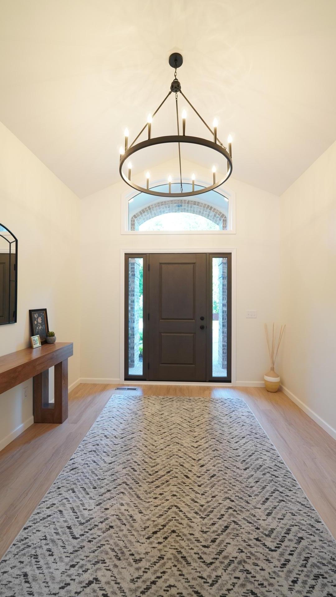 The considerable, vaulted front foyer makes a wonderful first impression with such elements as the brand new front door, flooring, paint and the 12-light chandelier overhead.
