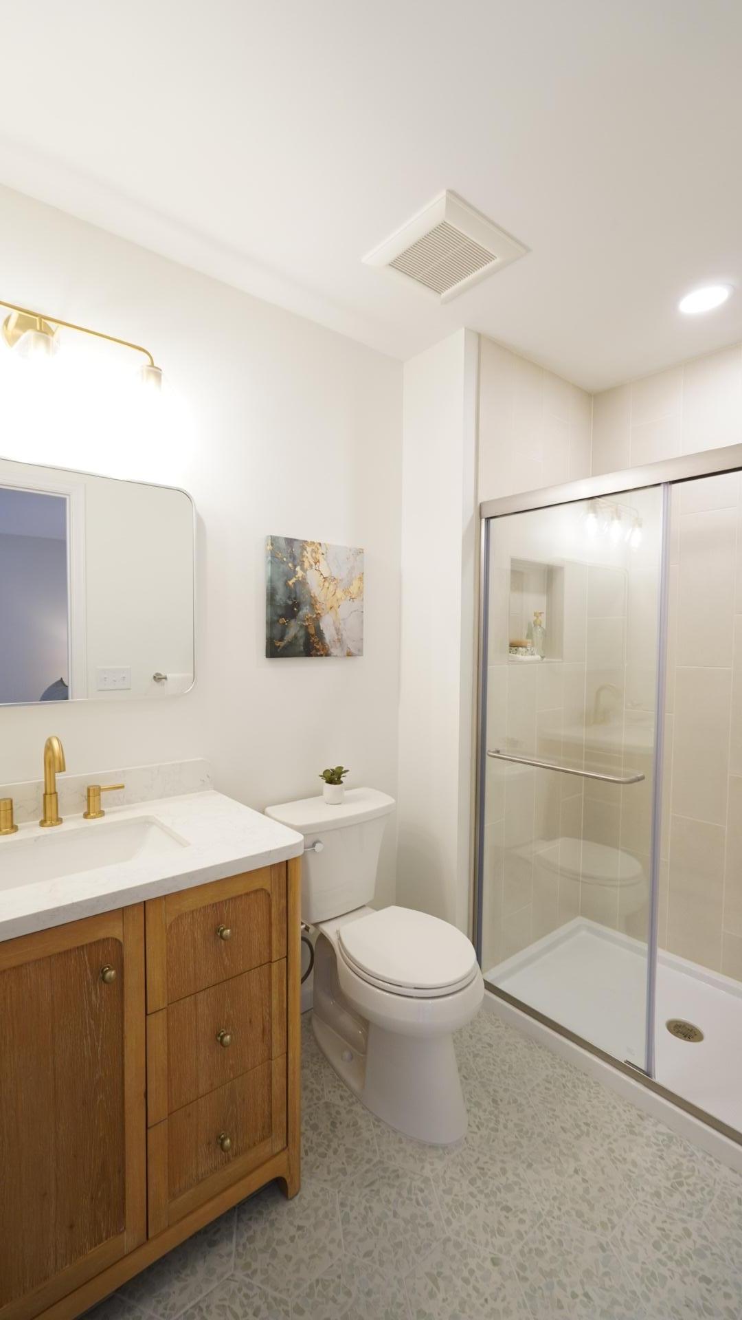Bath 5 is a fully remodeled 3/4 bath featuring a designer vanity, new lighting and custom tile work.