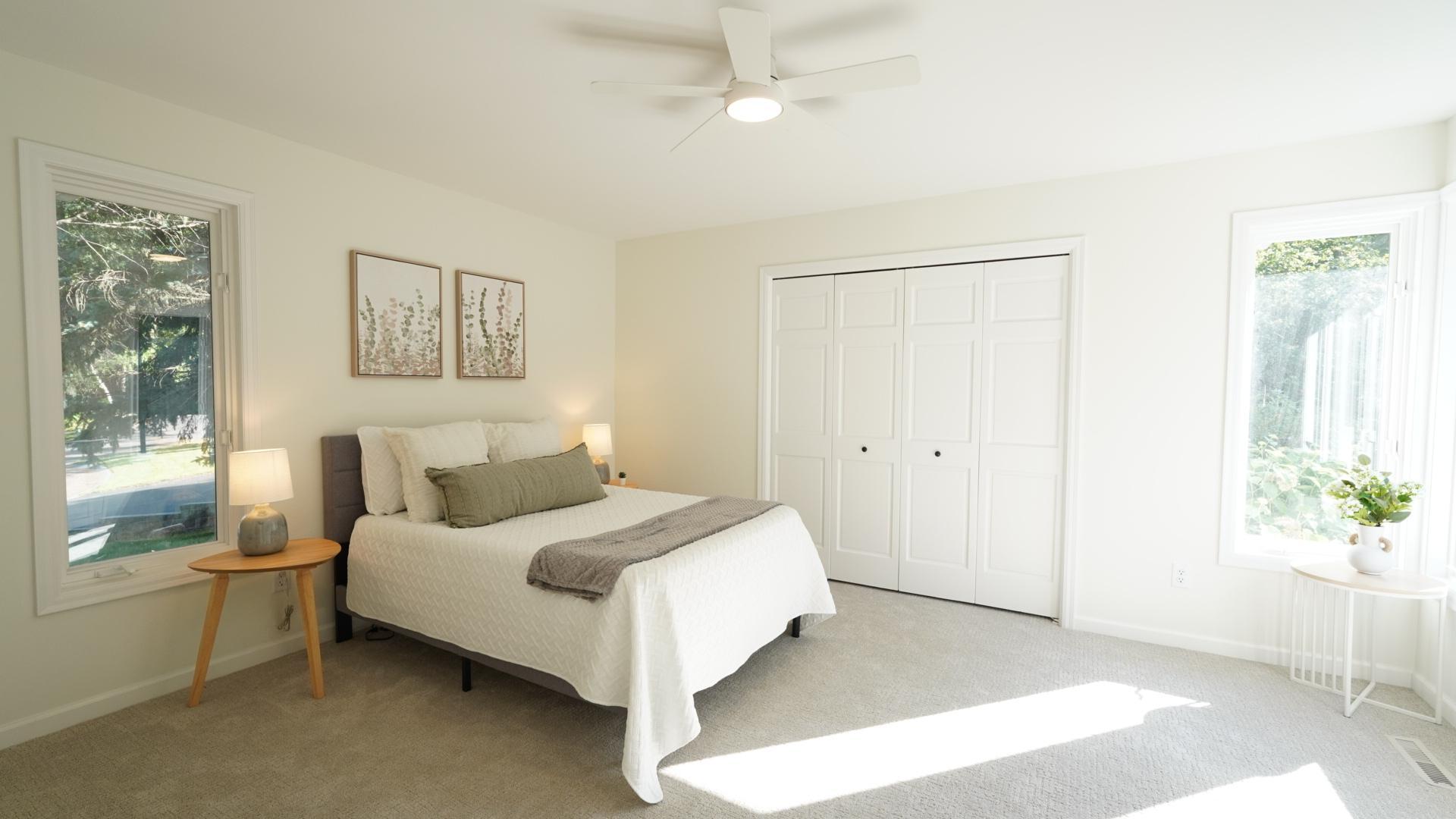 Bedroom 5 is filled with natural light from two sides, has views of the patio and pool area, and an oversized closet with a brand new closet system. It also features a new ceiling fan, carpet and fresh paint.