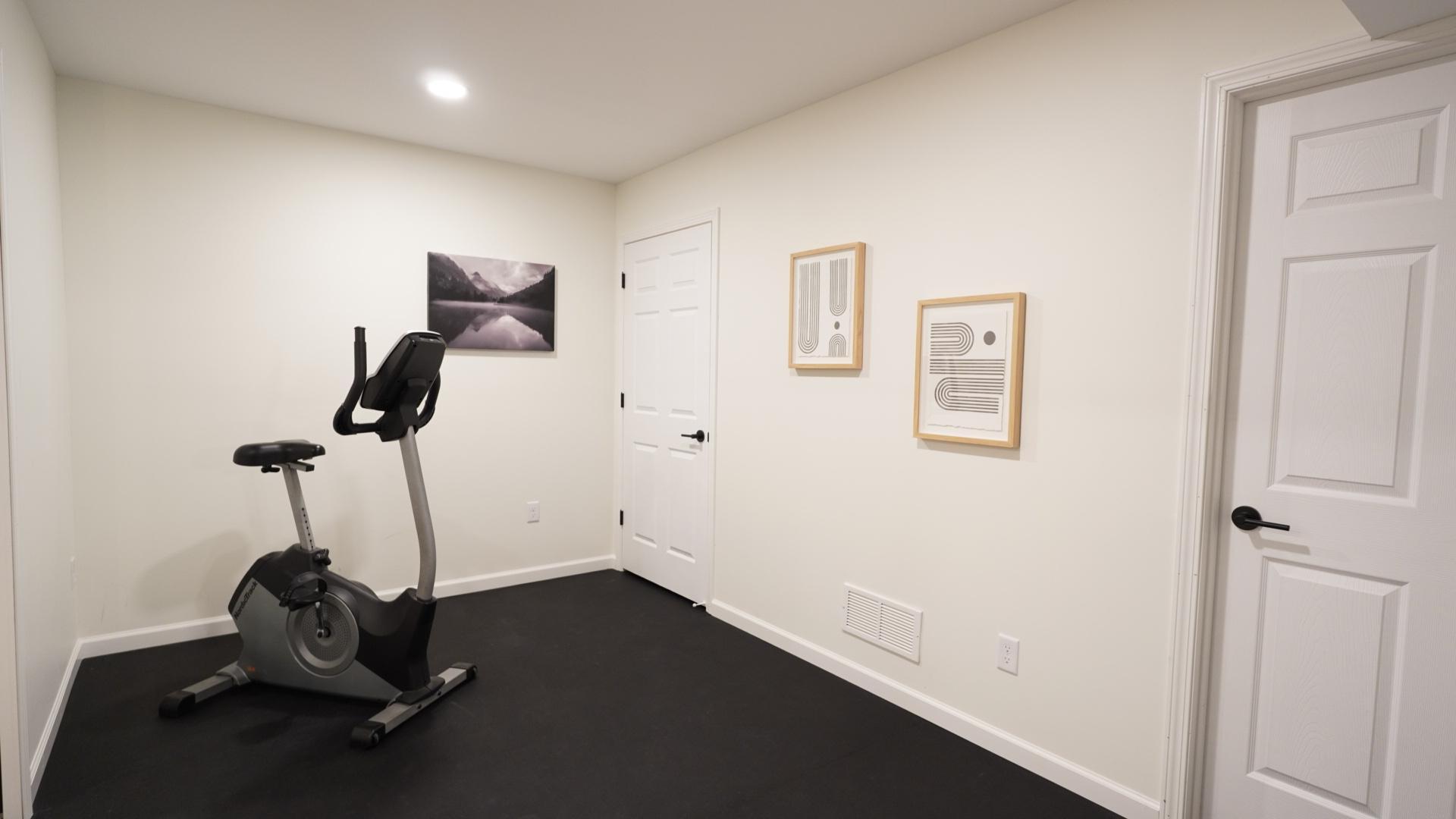 The workout room, located at the back of the lower level, is spacious and features brand new resilient rubber gym flooring and a large finished closet.