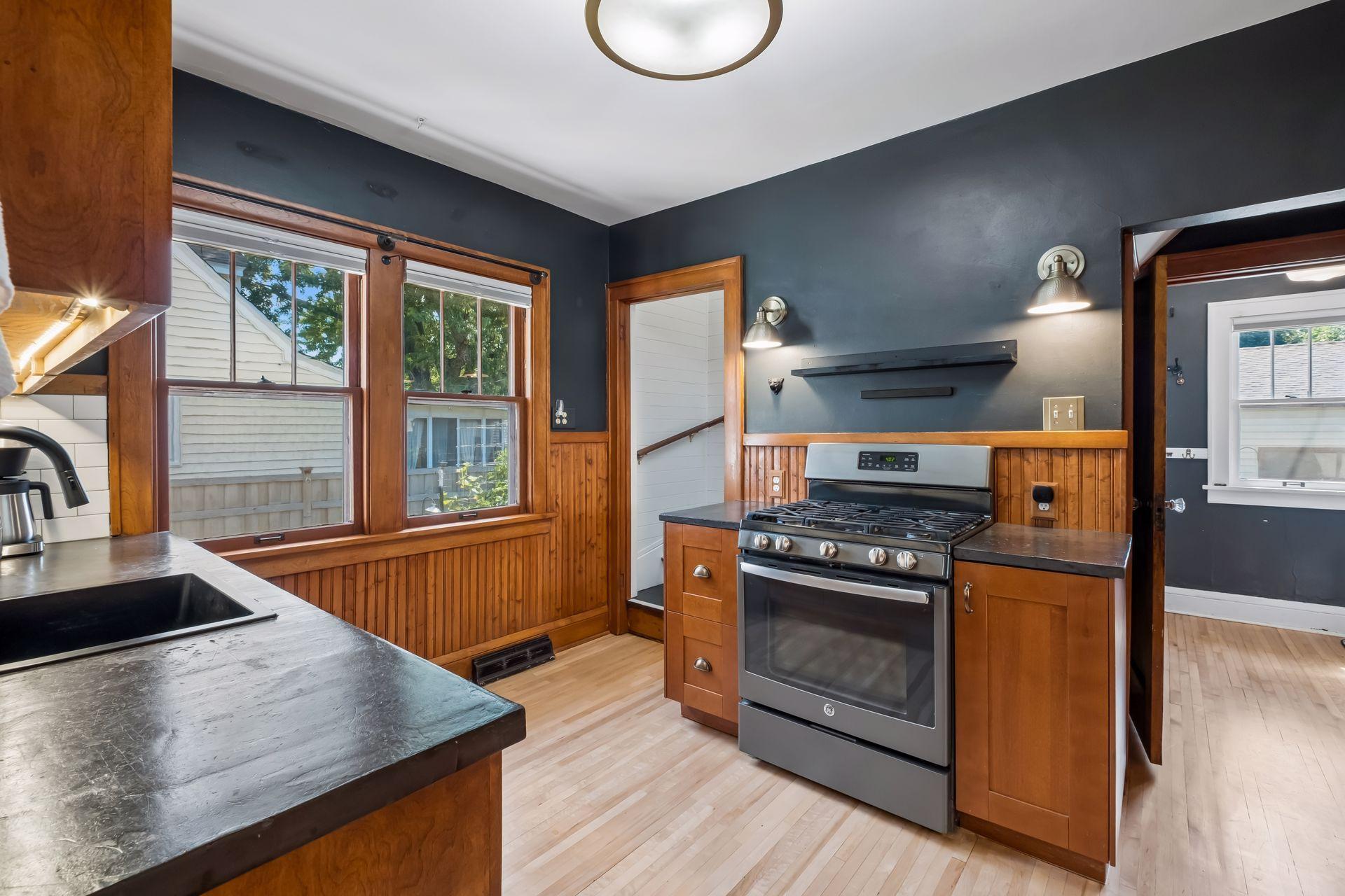 An adjacent rear mudroom/pantry also provides a walkout to the backyard.