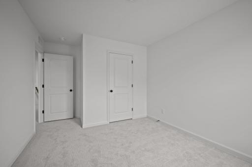 Comfortable secondary bedroom in the McBee plan ideal for guests or family use. Images are from a similar home, interior selections may differ
