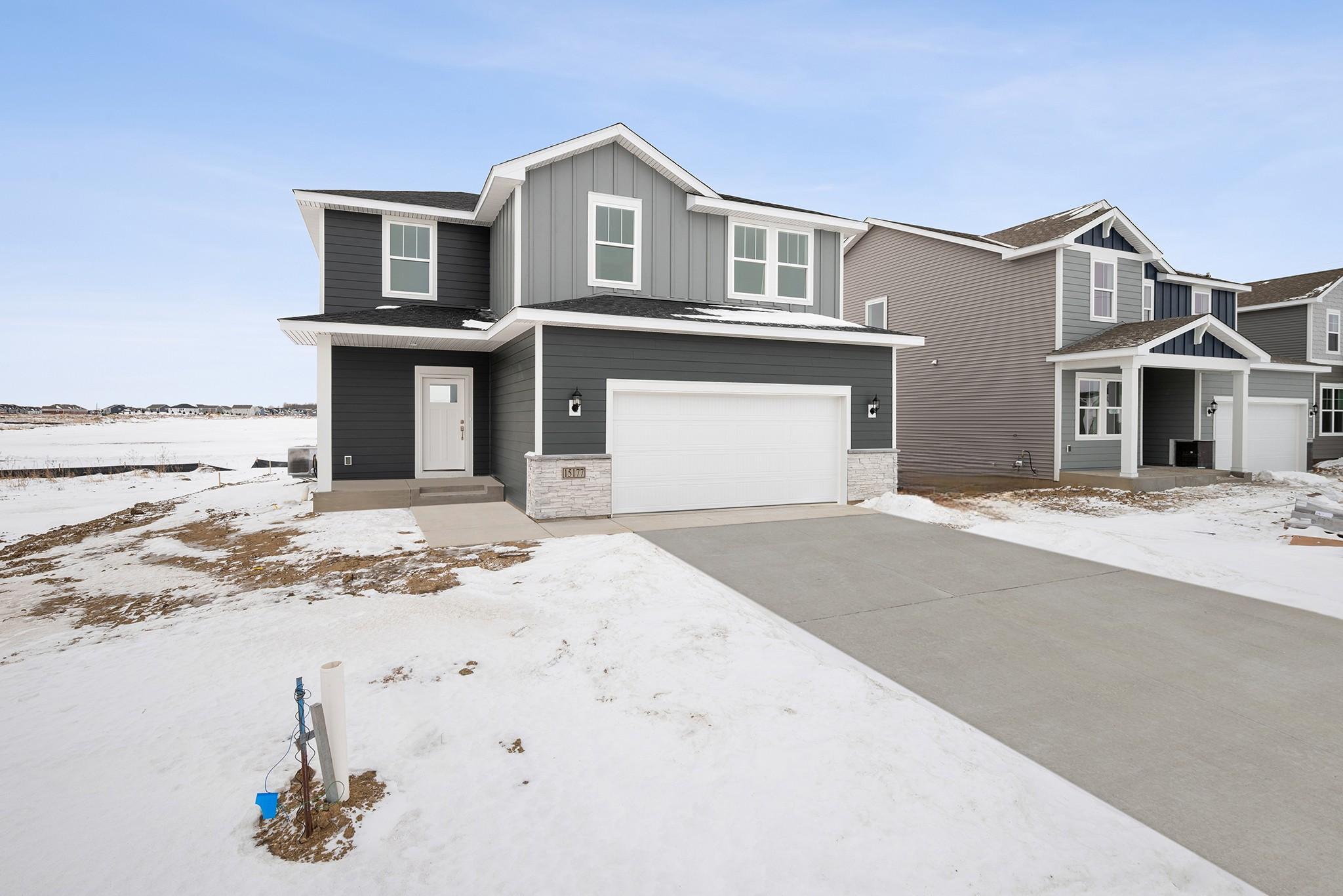 The exterior presents a clean, modern design with complementary siding, crisp trim, and an attached two-car garage for everyday convenience. Images of similar home, interior selections differ.