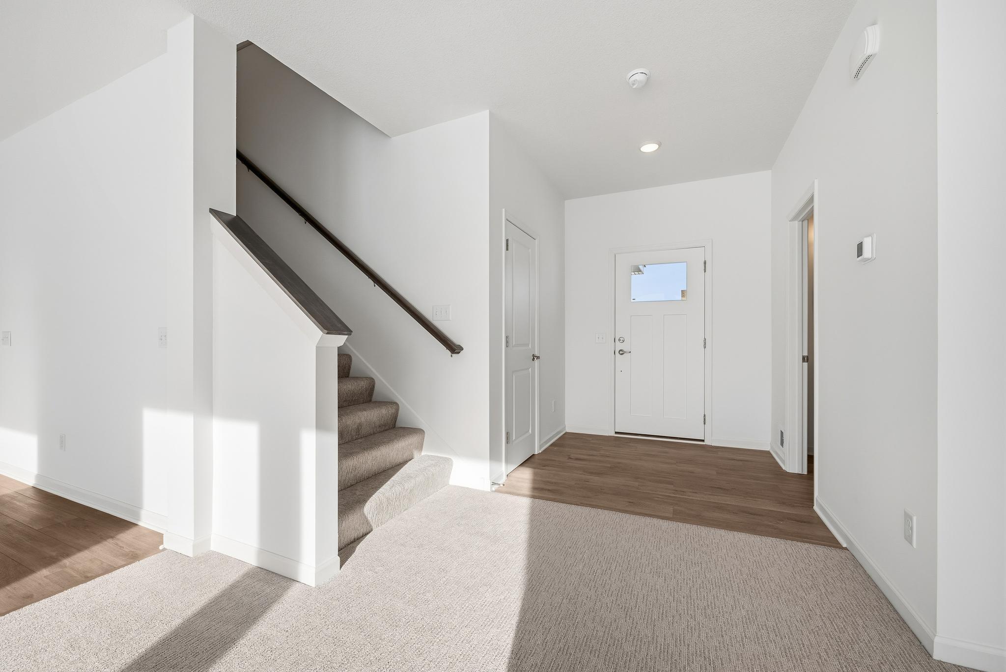The welcoming entryway offers a bright and open introduction to the home, highlighted by durable flooring and clean, neutral finishes. Images of similar home, interior selections differ.