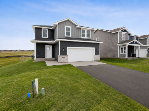 The exterior presents a clean, modern design with complementary siding, crisp trim, and an attached two-car garage for everyday convenience. Images of similar home, selections differ.