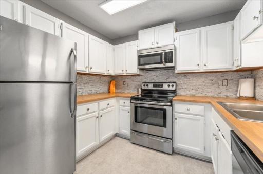 Updated Kitchen with Stainless Steel appliances and butcher block countertops