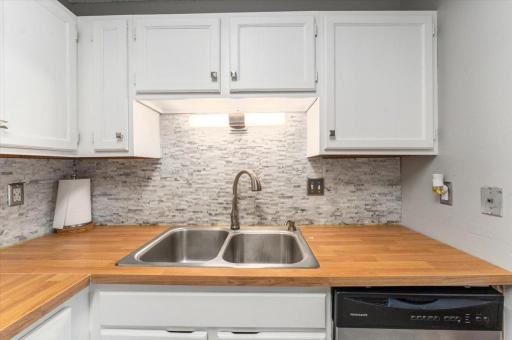 Double sink with Smart Touch faucet. Contemporary light fixture over the sink enhances both function and style.