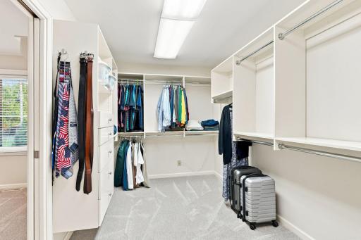 Large primary walk-in closet with built in storage