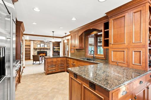 Large prep areas and kitchen sick with bay window looking into the sunroom