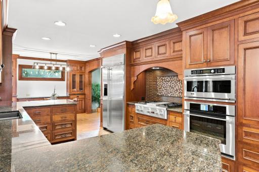 Stainless steal appliances, granite counter tops, beautiful cabinetry and range area