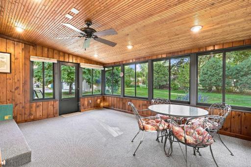 Sunroom with vaulted ceilings and wrap around windows for ample natural light!