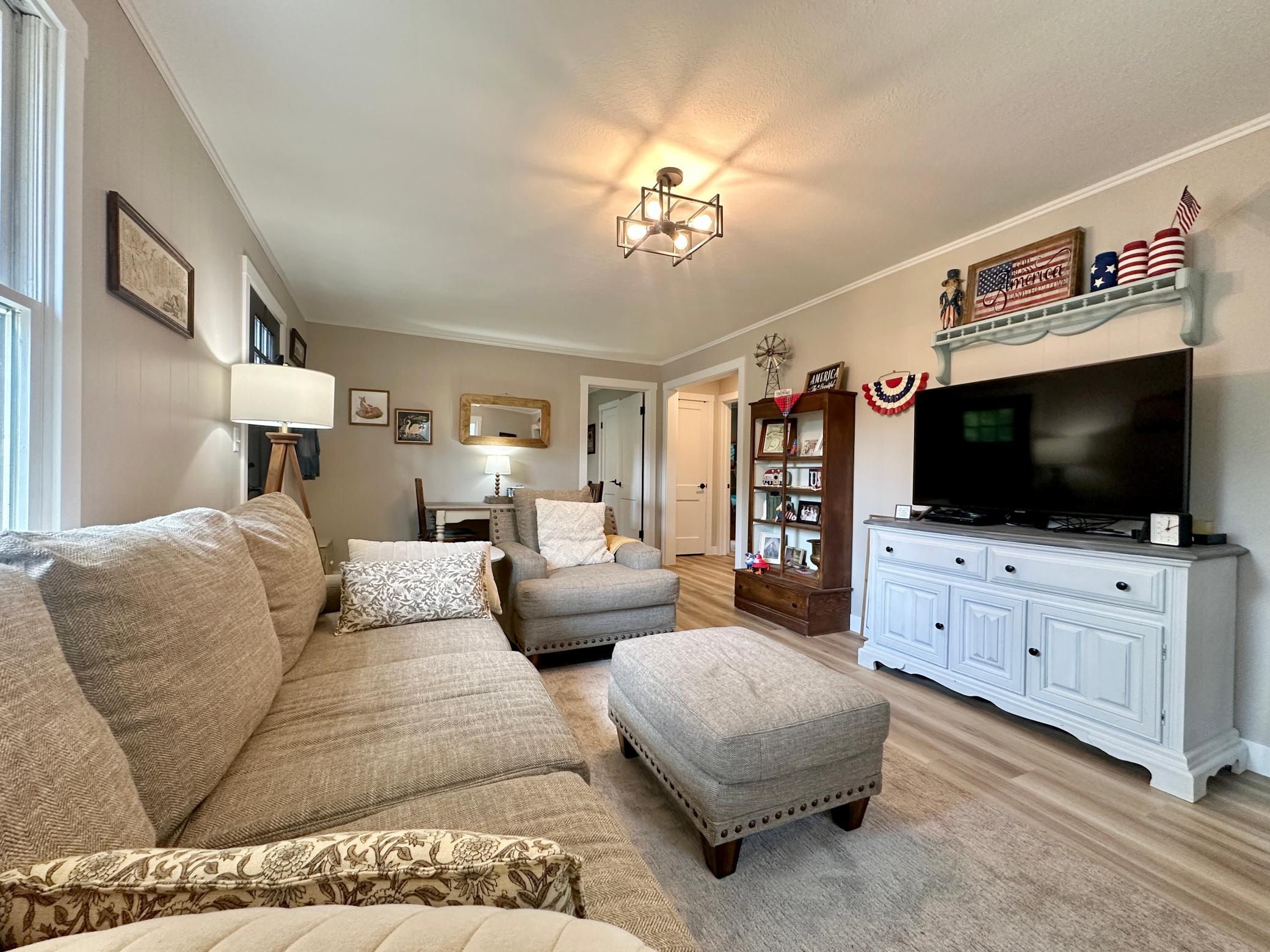 A look at the living room with the kitchen immediately to the right and full bath and 2 bedrooms in back.