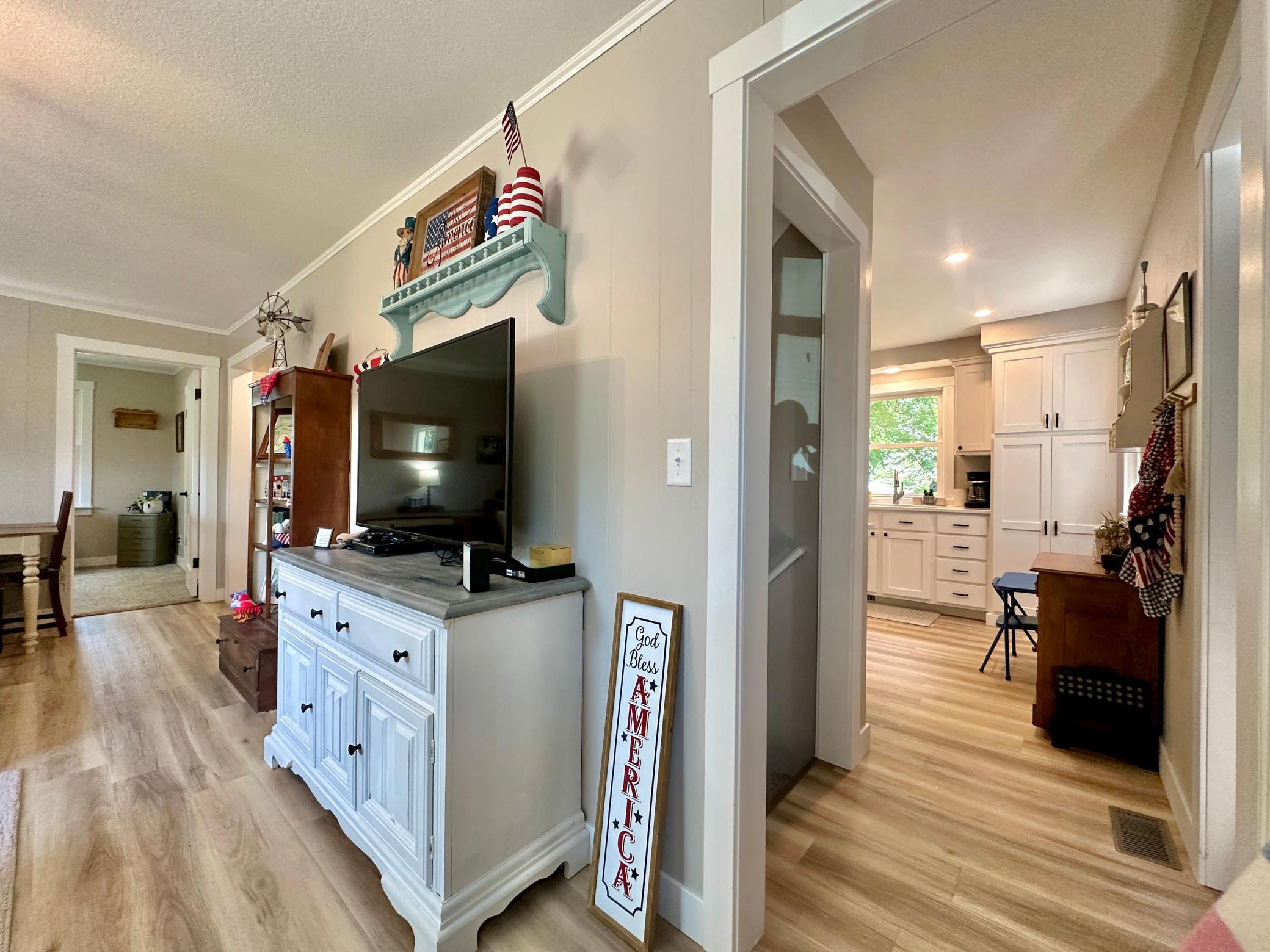 A glimpse into the kitchen and thru the living room.