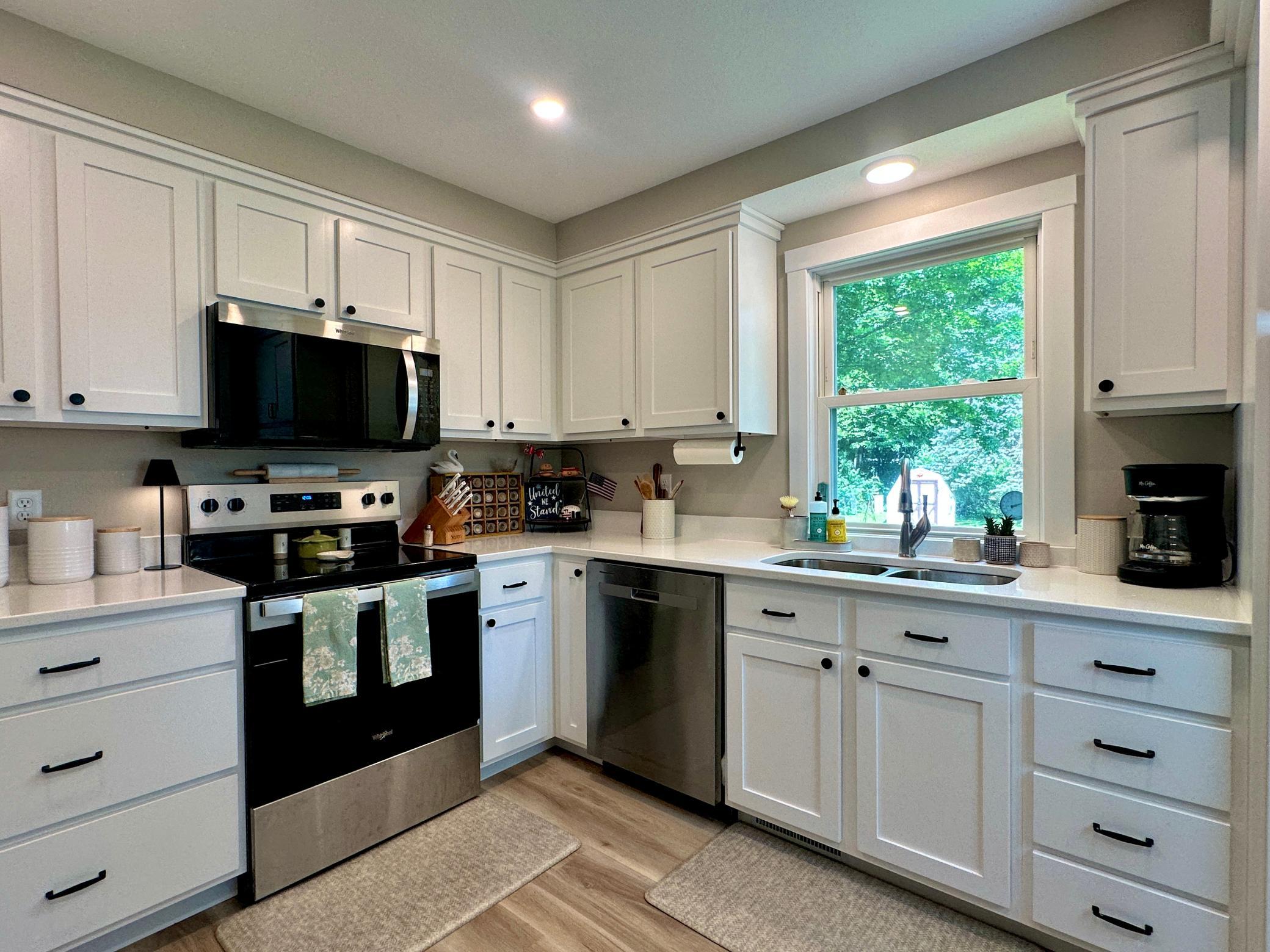 Great counter space and cabinet space in this kitchen and a kitchen window to conveniently watch activities in the back yard.