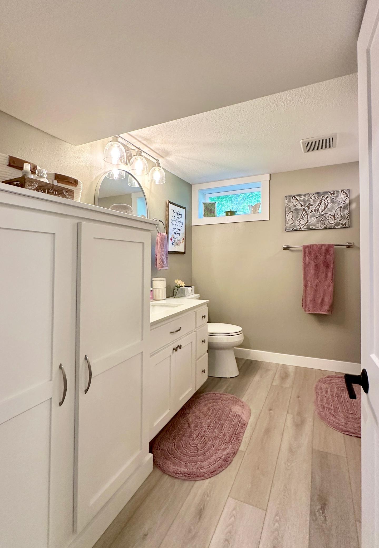 The lower level bath is nicely updated with lots of storage.