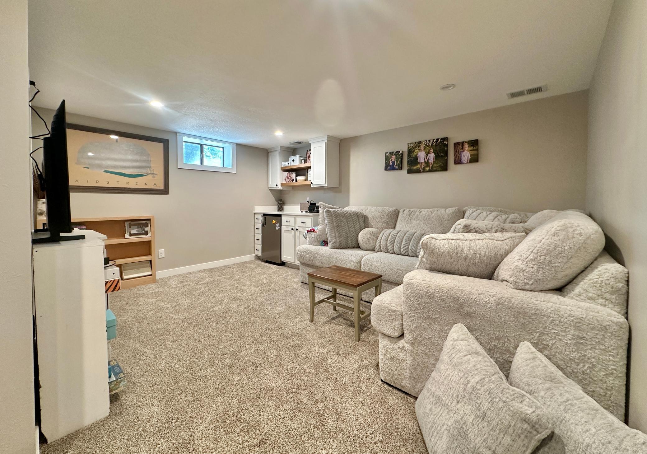 Newer carpet beautifies and cozies up the lower level family room.