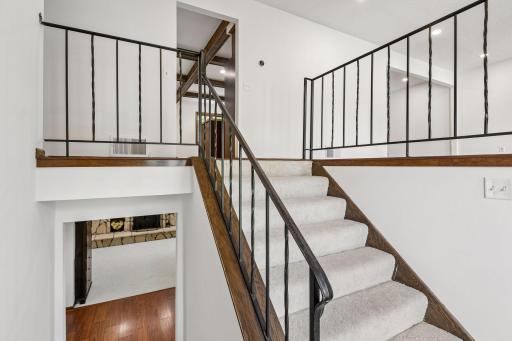 Entry enveloped with new carpeting on stairs