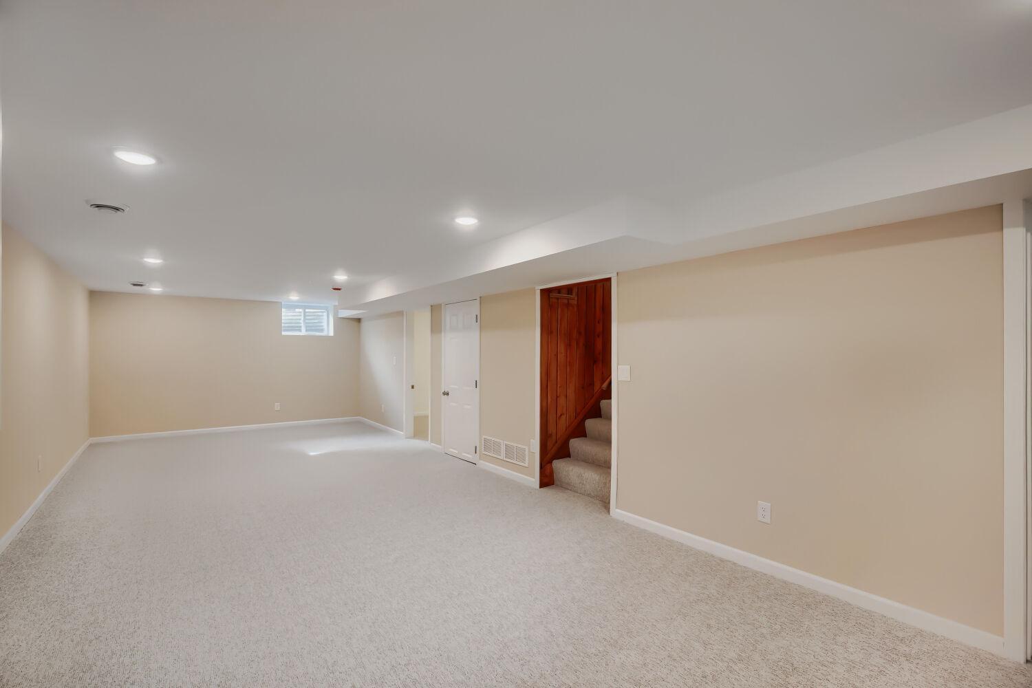 7711 Division St - Head downstairs to discover a stunning lower-level renovation featuring a large flex space adjacent to a 3rd bedroom and bath/laundry suite.