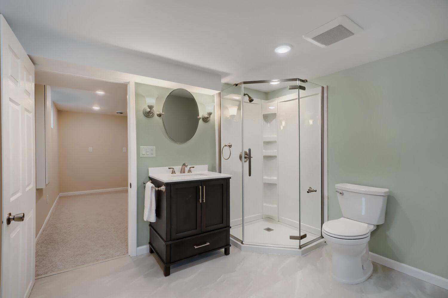 7711 Division St - It's all about your comfort as you enjoy this ocean-inspired bath/laundry suite.