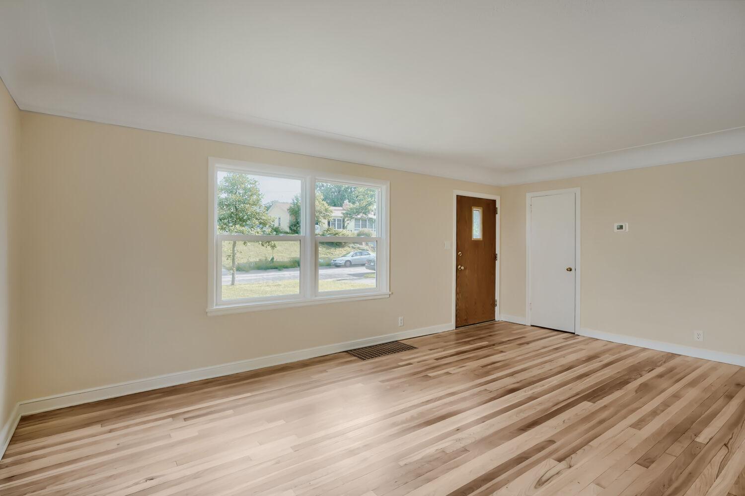 7711 Division St - As you enter, you are greeted with natural sunlight and beautifully refinished hardwood floors.