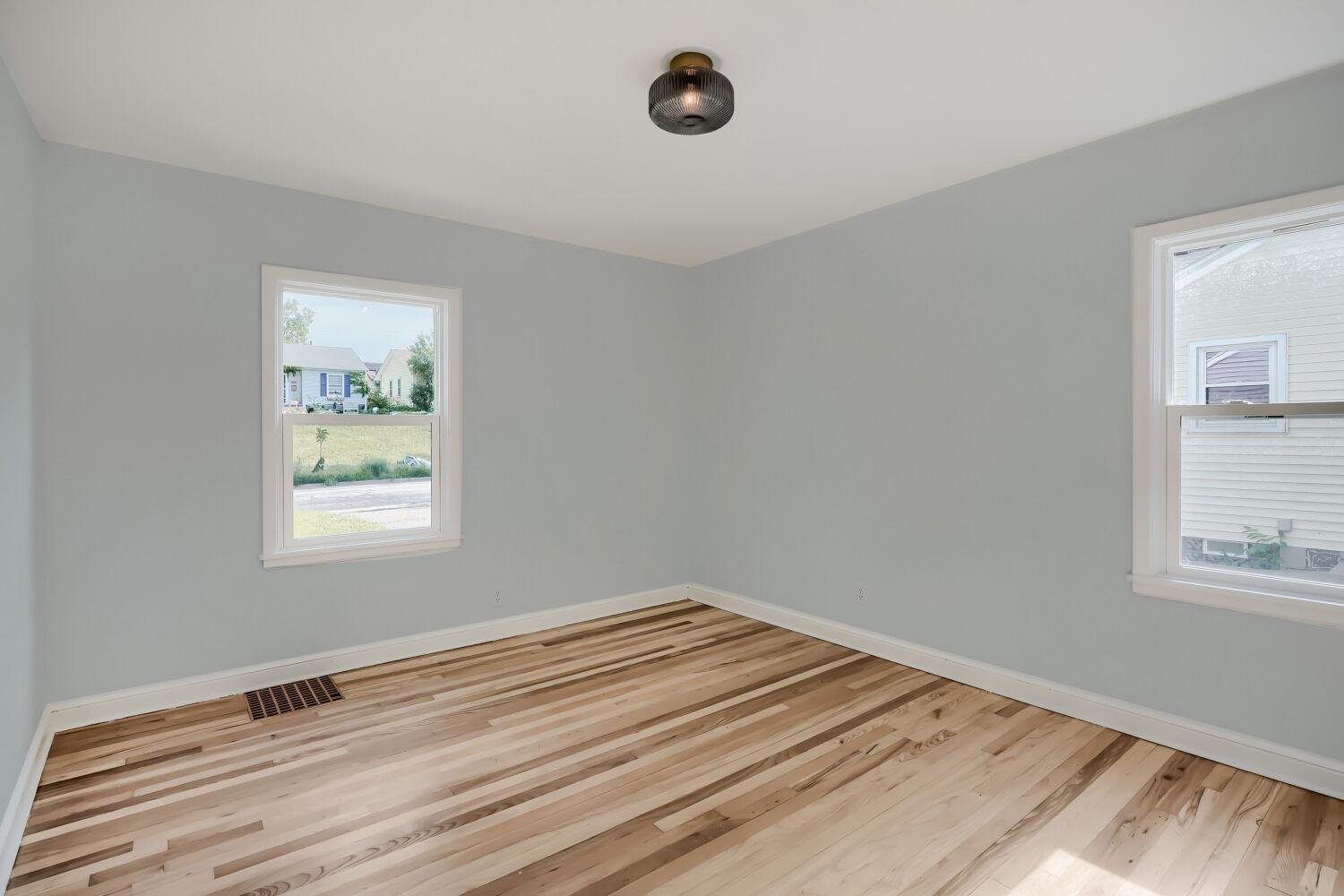 7711 Division St - The primary bedroom is peaceful and clean as a whistle.