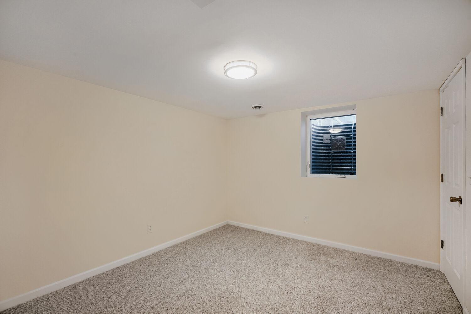 7711 Division St - 3rd bedroom on lower level has a brand new Egress window facing backyard.