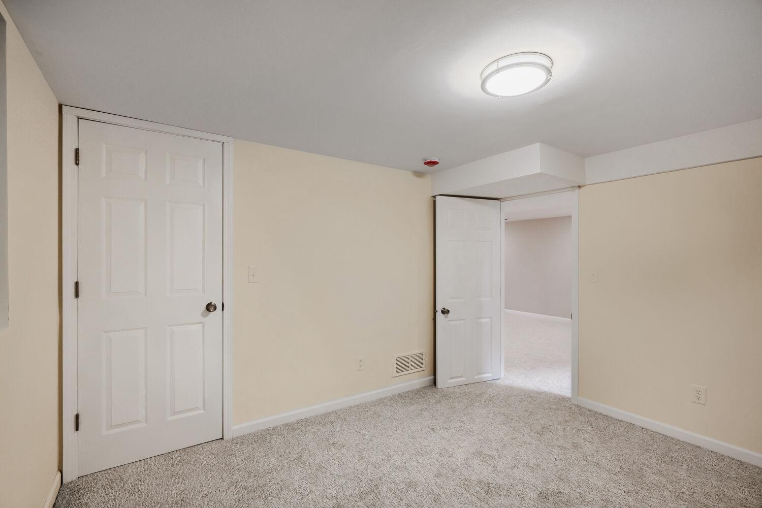 7711 Division St - Lower level bedroom has new carpeting to match family room.