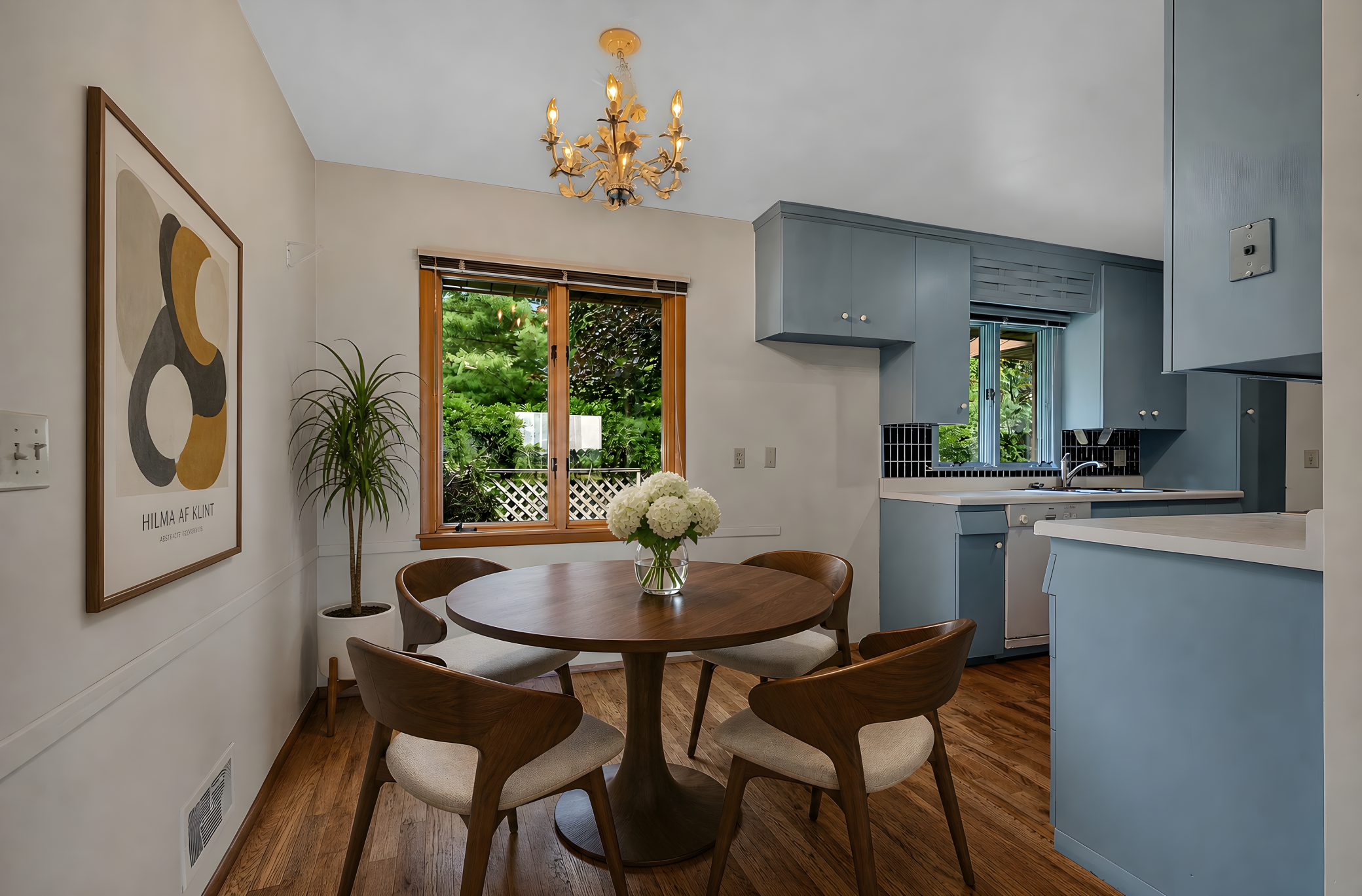 Dinette and Kitchen Area - Virtually Staged with Furniture and Wood Flooring