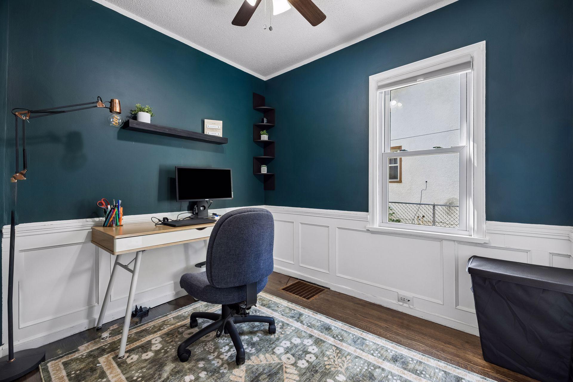 Flexible by design. Currently staged as a home office, this main-level bedroom features hardwood floors, beautiful natural light, and the versatility to serve as a guest room, nursery, or workspace.