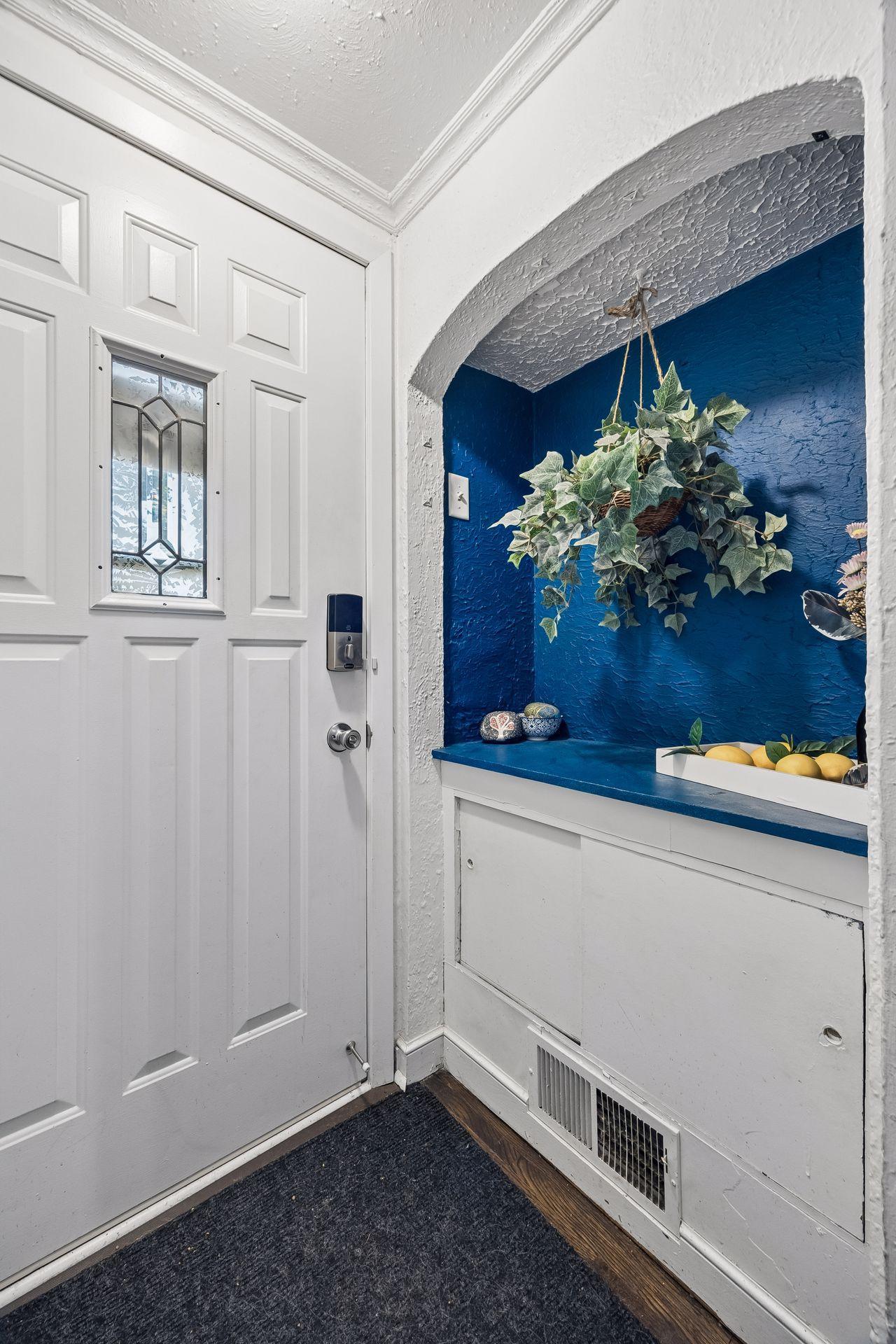 It's the little details that make a house feel like home. This charming entry features an original arched niche with built-in storage, a beautiful example of the home's 1940's craftsmanship