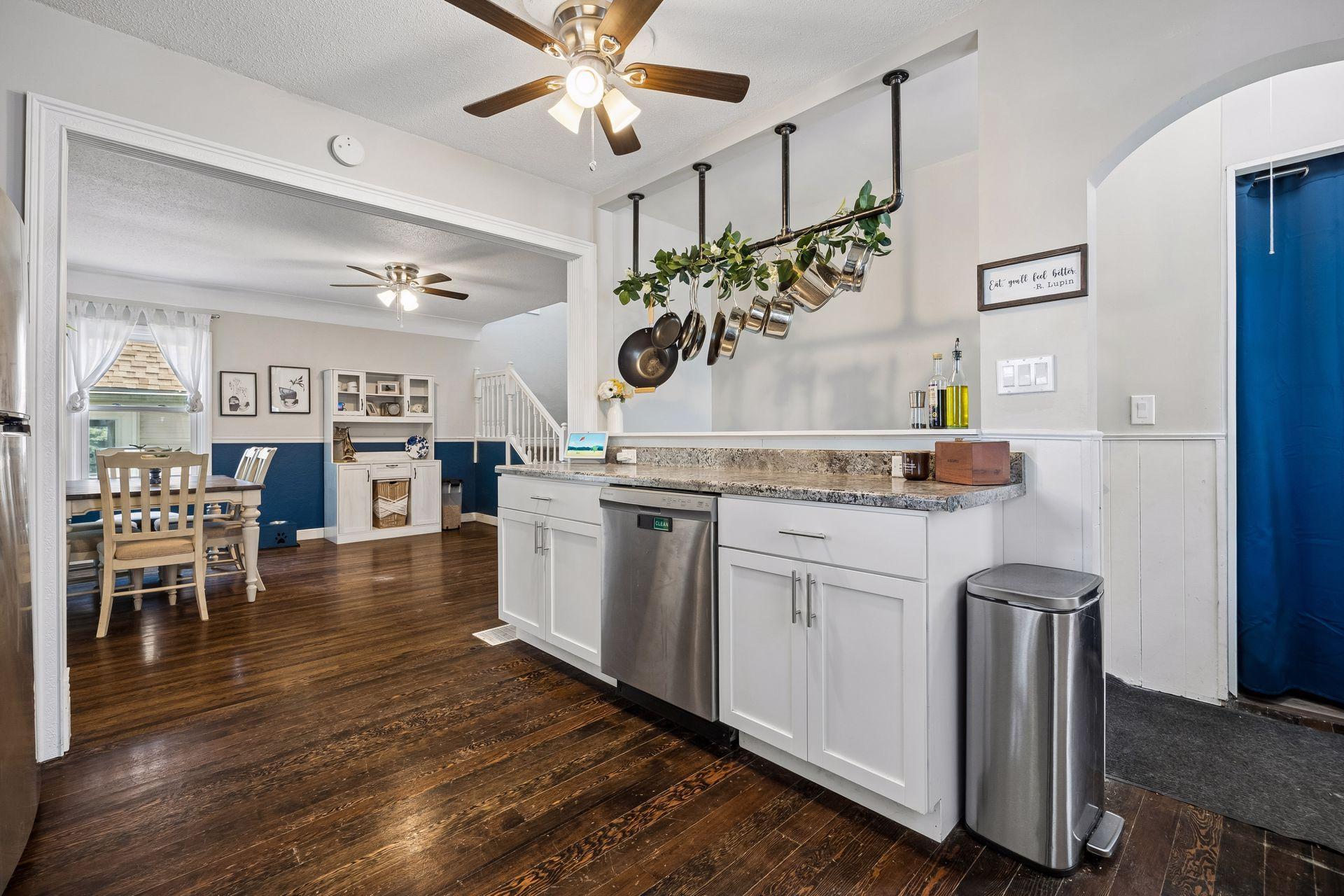 Every detail has a purpose. The custom hanging pot rack adds a touch of chef-inspired design while freeing up cabinet space and keeping cookware close at hand.