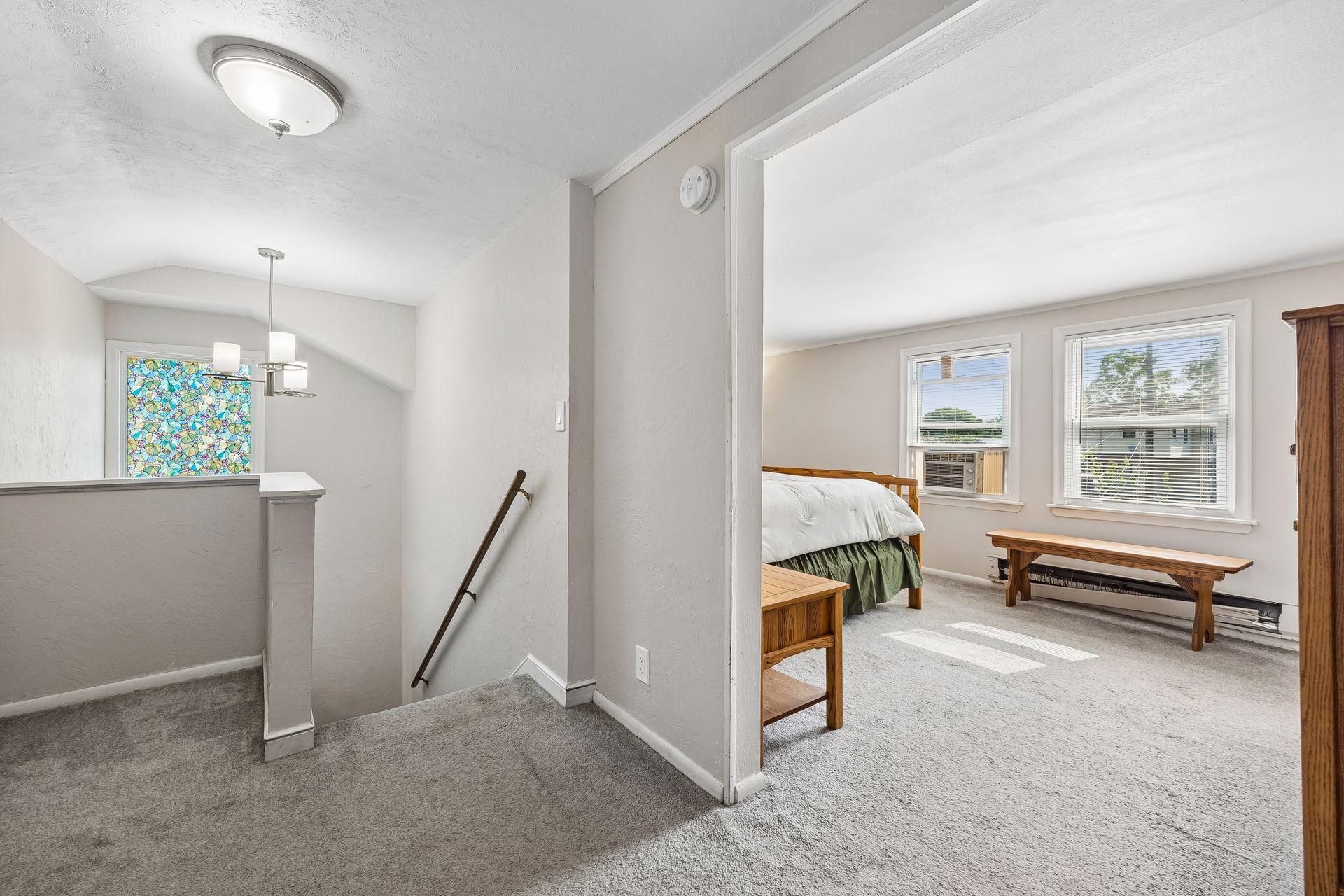 A welcoming introduction to the primary suite. The upper-level landing creates a sense of privacy while setting the stage for the spacious owner's retreat.