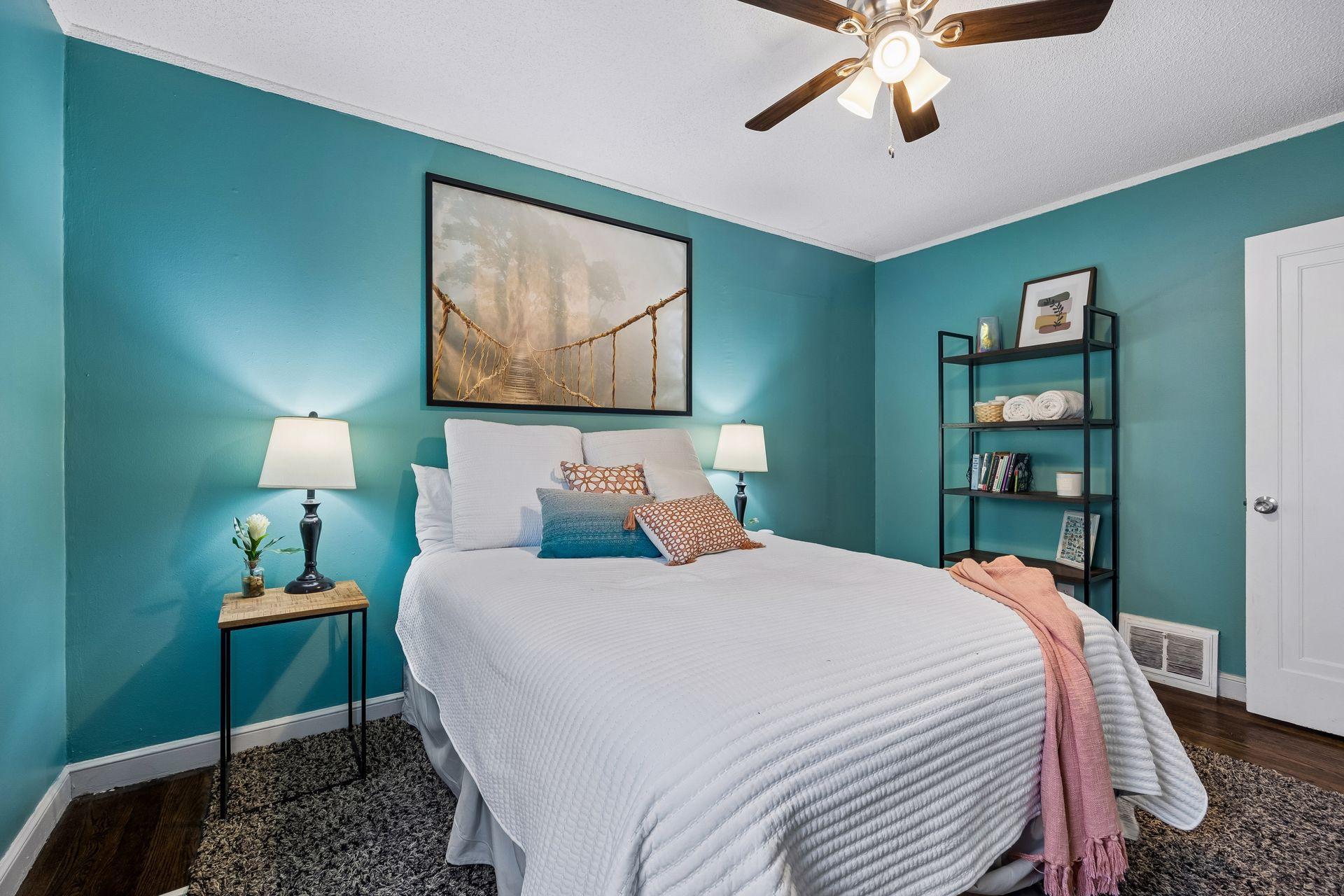 Comfortably sized and filled with natural light. This 13.5' x 10' main-level bedroom features hardwood floors and plenty of space for a queen-sized bed and additional furnishings.